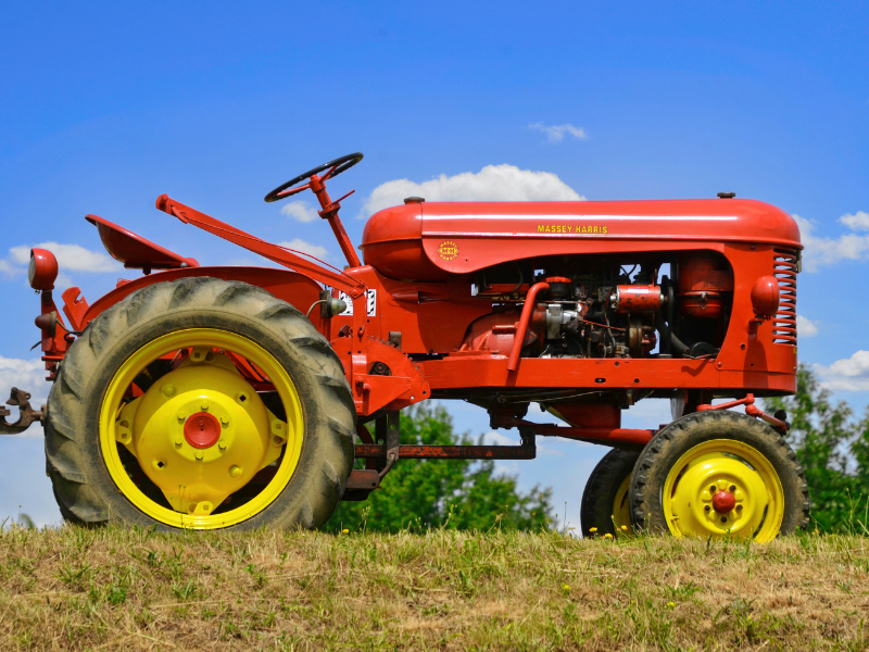 red tractor in field with yellow wheels